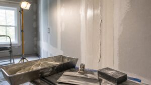 Drywall finishing tools and smooth joint compound on a wall seam