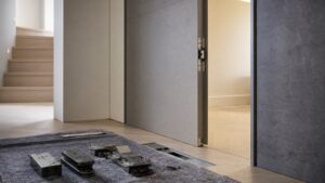 Concealed door hardware being fitted into a flush modern hallway door