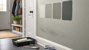 Mudroom wall with neutral paint samples roller brush and scuff area